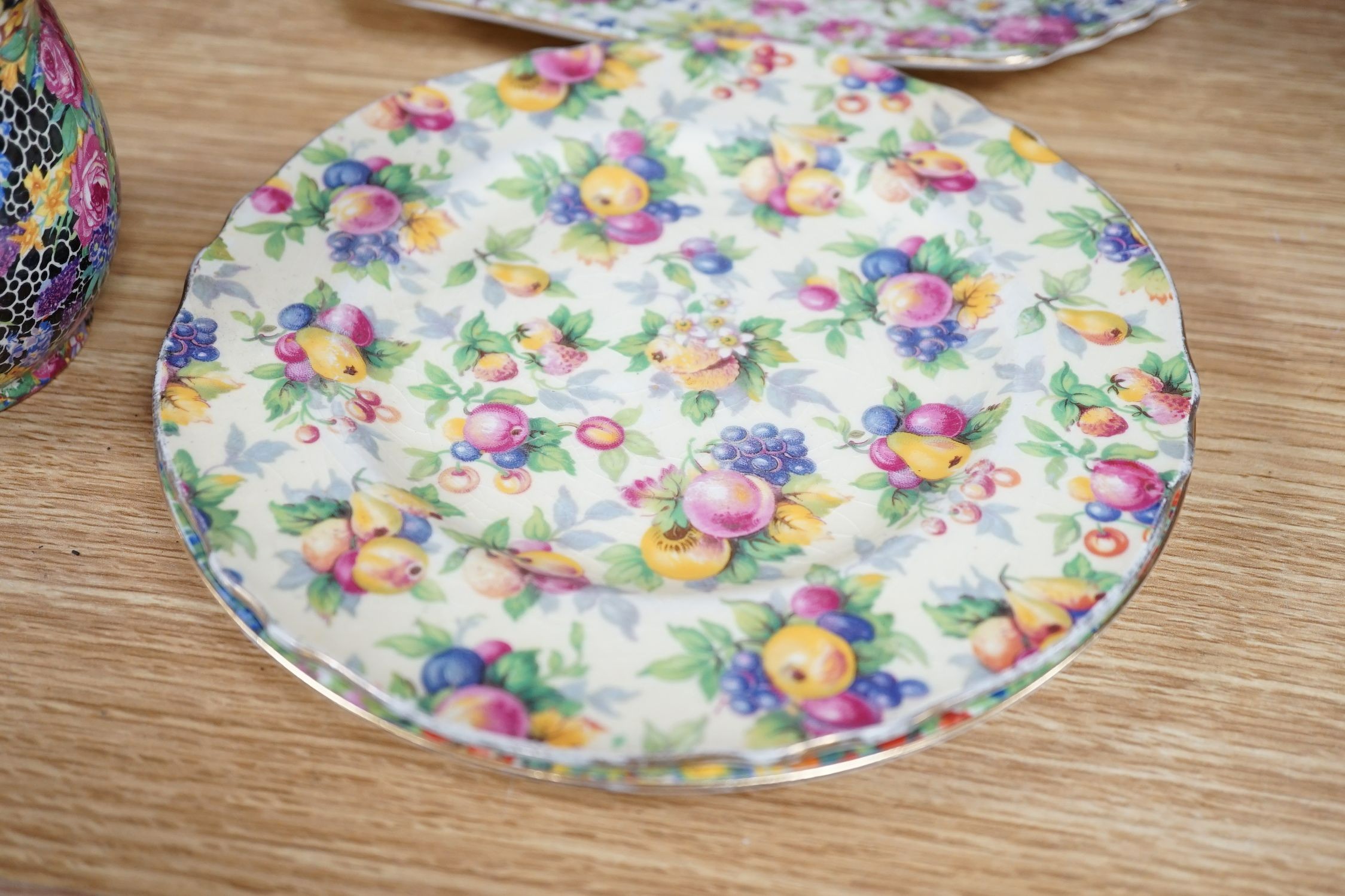 A Clarice Cliff tea cup, a collection of chintz patterned teaware, a lustre bowl and a honey pot and cover